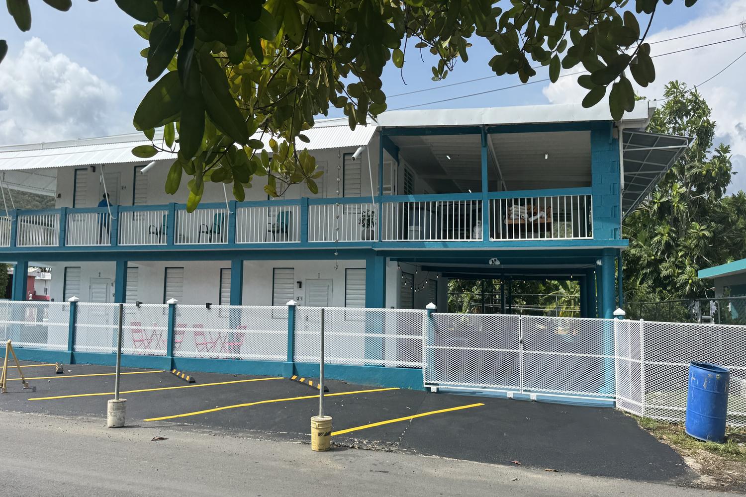 Front elevation showing the guest suites and shaded second-floor balcony